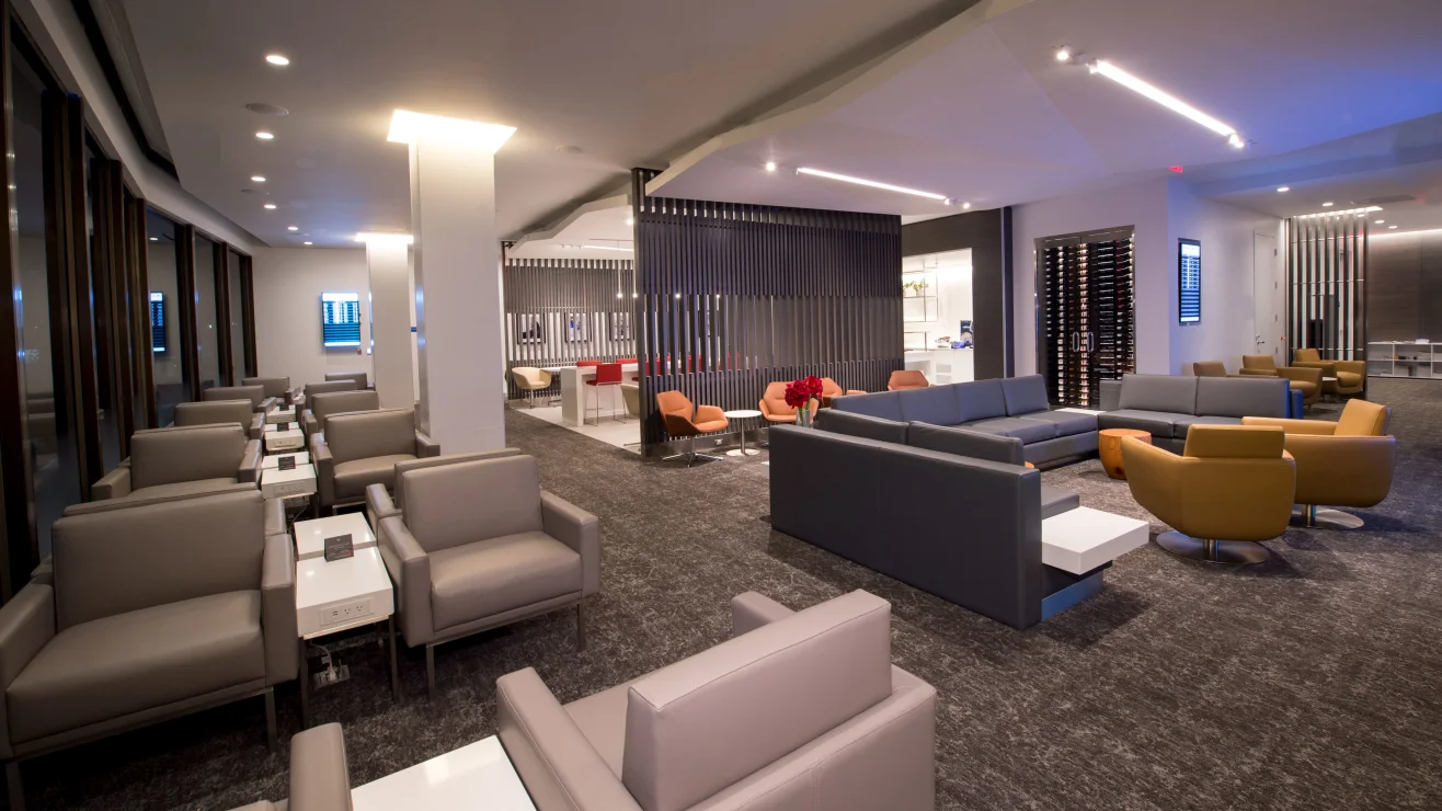 Quiet modern airport lounge with armchairs, sofas and work tables