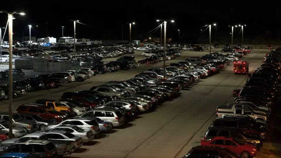 Long-term airport parking lot illuminated at night