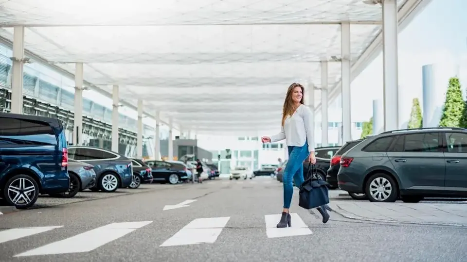 Traveler walking through an airport parking area